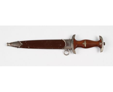 A German Third Reich Nazi SA dagger, the brown wooden handle having inset eagle and swastika with white metal mounts, with en