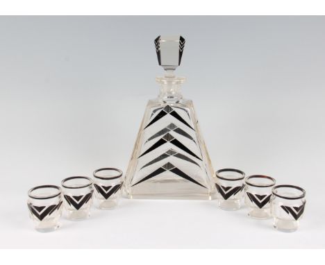 An Art Deco decanter and six glasses, each having an angular black enamel and cut design to the bodies, height 26cm.
