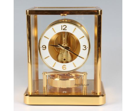 A Jaeger LeCoultre 'Atmos' mantel clock, the white chapter ring with Arabic numeral quarterly hour markers and dagger batons 
