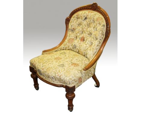 A Victorian walnut nursing chair with carved top rail above button back on short decorative and fluted supports to front and 