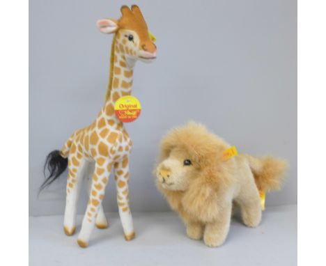 A Steiff giraffe and lion, buttons and labels intact 