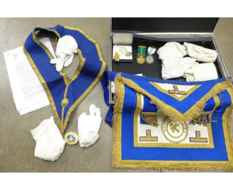 A briefcase with Masonic apron and gloves, a box of Masonic Trust medallions (Nottinghamshire) 