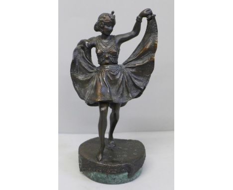A bronze Art Deco dancing girl figure on a circular base, with a hinged skirt, 13.5cm 