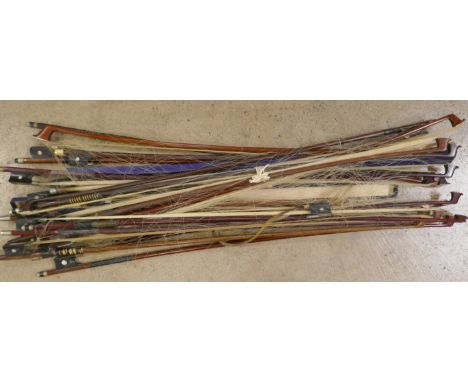 A collection of violin and cello bows, one marked Penzel and one marked Japan 