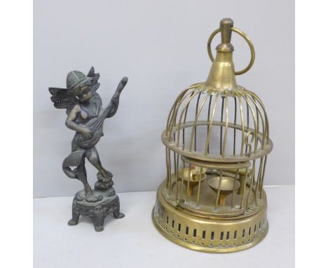 A brass bird cage and a bronze figure of a cherub playing a mandolin 