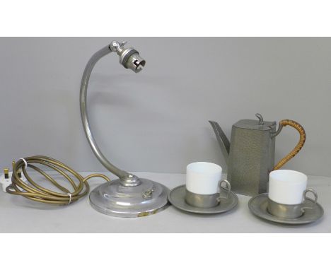 Two Limoges coffee cans with pewter holders and saucers marked Etain France, an Art Deco table lamp base and a Civil hammered