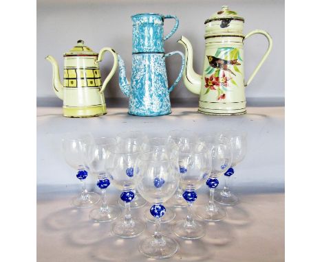 Three enamel coffee pots and ten wine glasses with blue mottled waisted stems. 
