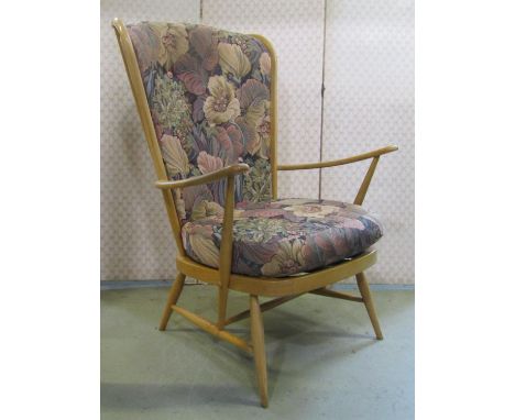 A pair of vintage Ercol light beechwood Windsor style high stick back open arm chairs with loose cushions 