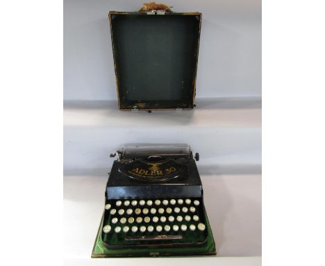 A German Adler 30 typewriter, with forward striking keys, in its ordinal carrying case. 
