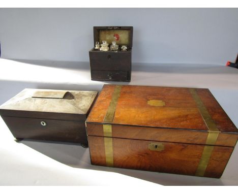 A Georgian sarcophagus mahogany tea caddy, a Georgian writing slope, and a wooden apothecary box with various glass bottles o