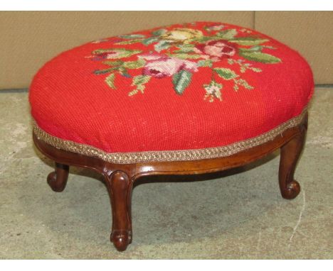 A small Victorian foot stool with oval floral tapestry top raised on scrolled cabriole supports 35cm x 28cm x18cm h 