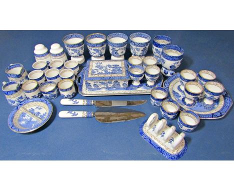 A collection of Booths Old Willow table wares, principally eggs cups, toast rack, condiments, small jugs, reversible egg cups