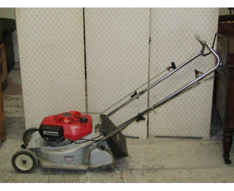 A Honda HR173 petrol driven rotary lawn mower with rear roller, complete with grass collection bag 