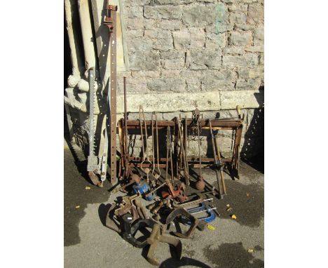Two pairs of antique cast iron spoke implement wheels 38 cm and 25 cm in diameter, a pair weathered iron trestles, vintage to