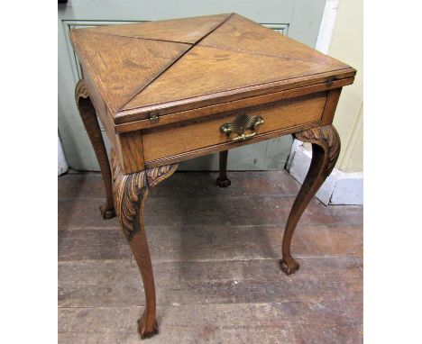 Edwardian oak envelope card table with frieze drawer, shaped supports and claw and ball feet, 55cm square 