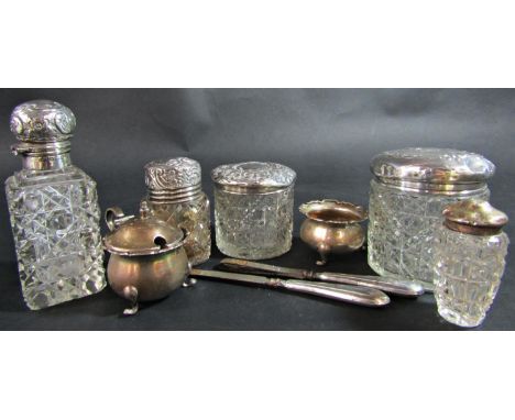 A varied collection of silver comprising five silver capped glass jars, salt and mustard pots and two manicure tools 