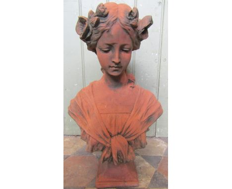 A cast composition stone head and shoulder bust of an Art Nouveau style female character with terracotta finish, 46 cm high 