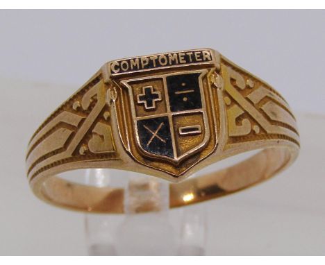 Yellow metal 'Comptometer' award ring with enamelled mathematical symbols, size Q/R, 3.2g 