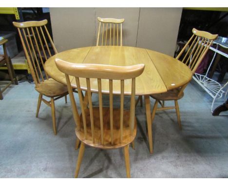 A vintage Ercol light elm and beechwood oval drop leaf dining table, raised on square tapered and splayed supports, 114cm x 1