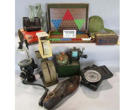 A miscellaneous collection of items including a fish glug jug, vintage hole puncher , a pair of wooden shoe trees, a Solitair