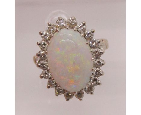 18ct cabochon opal and diamond oval cluster ring, opal 14 x 9mm approx, maker 'KJ', London 1975, size L, 6.6g 