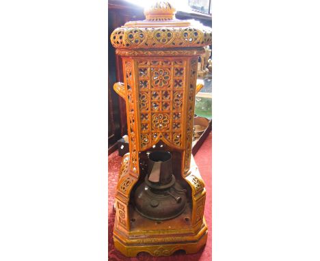 A Burmantofts Patent Veritas Oil Stove, serial Number R N 245520, amber yellow ceramic with a later electric light addition. 