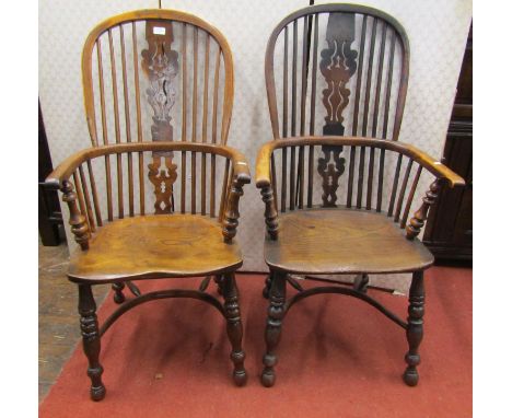 An almost identical matched pair of Georgian Windsor comb back elbow chairs in elm and yew wood, with Christmas tree pattern 