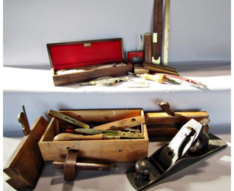 A collection of vintage tools, including planes, wooden routing tools, rulers, spirit levels, oil tins, and a gun cleaning ki