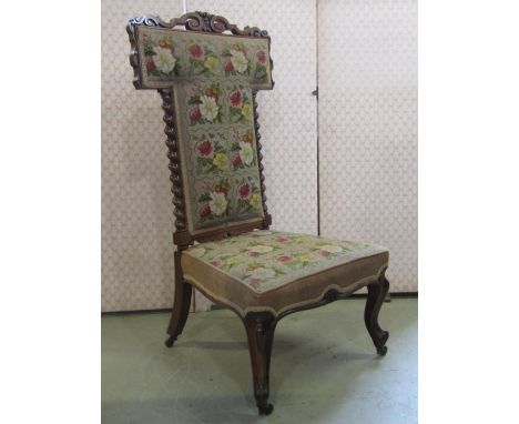 A Victorian prie-dieu / nursing chair, with floral tapestry seat and T shaped back, in a rosewood show wood frame 