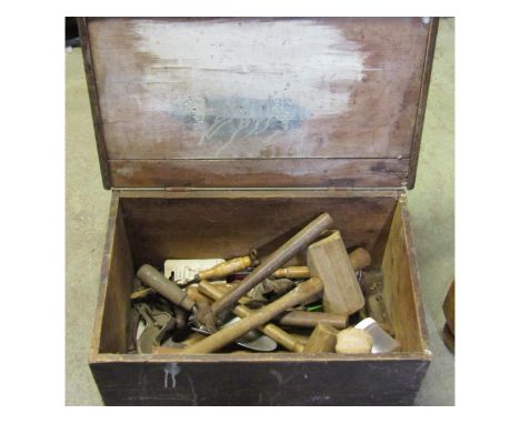 A small antique stained pine box with  hinged lid, containing small collection of hand tools 