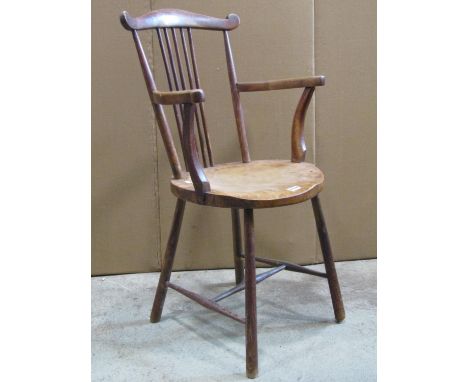 An Edwardian stick back open elbow chair with circular dished seat 