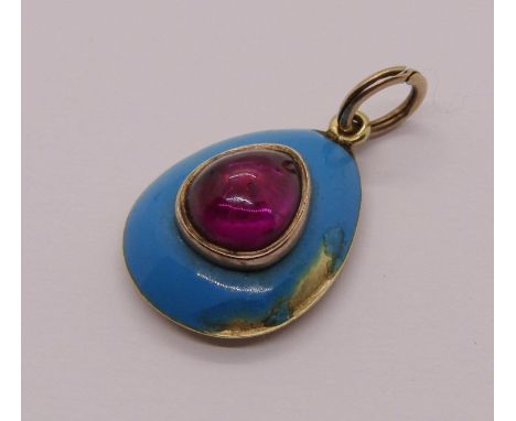 Victorian yellow metal mourning pendant set with a pear-cut cabochon garnet on turquoise enamel ground, inscribed to reverse 