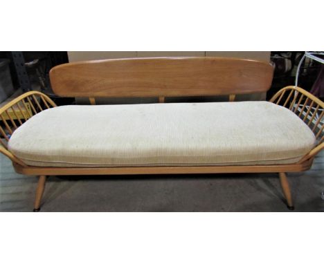 A vintage Ercol light elm and beechwood sofa bed, with panelled back, hoop and stick arms and loose cushion, 208cm wide 