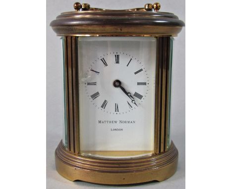 A Matthew Norman carriage clock with oval case and eight day time piece 