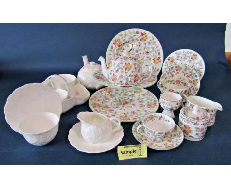 A collection of Minton's Haddon Hall tableware comprising dinner plates, tea cups and saucers, cake stand, etc, together with