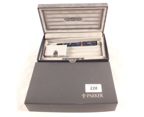A boxed Parker blue mottled cartridge fountain pen