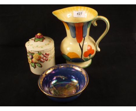 A Clarice Cliff fruit moulded jam pot, a Fieldings Devon lustrine ship decorated bowl and an Art Deco jug