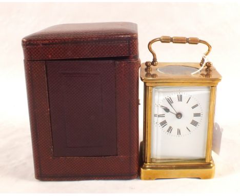 A cased Brass carriage clock and key