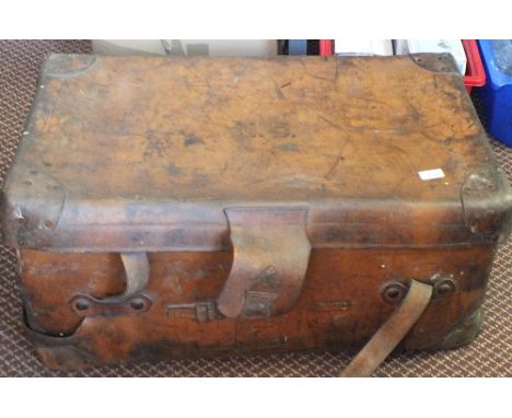 A leather trunk containing vintage paisley table cover, lace and linen