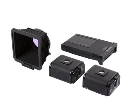Three Hasselblad film backs and a lens hood. To include two A12 6 x 6 magazines, a Polaroid 100 back, and a Hasselblad variab