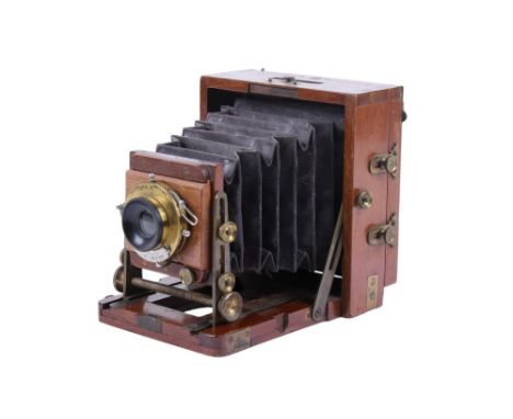 An antique brass and mahogany quarter-plate camera. No makers marks, name plate appears to have been removed. With an Eastman