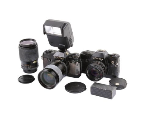 A Contax 137 MA Quartz 35mm SLR camera outfit. Two bodies; Black, Serial numbers 060243 & 038216. Both untested. With three l