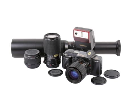 A Canon T70 35mm SLR camera outfit. Serial number 1278763. With three lenses; a Sigma Zoom-Master 35-70mm f2.8-4, a Sigma Zoo