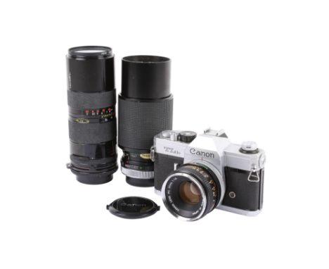 A Canon TLb 35mm SLR camera outfit. Chrome. Serial number 128684. With three lenses; a Canon FD 50mm f1.8, a Vivitar 75-205mm