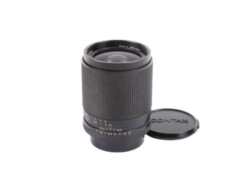 A Carl Zeiss 28mm f2 Distagon T* lens. Contax / Yashica mount. Serial number 5905183. With front and rear caps, and Contax 55