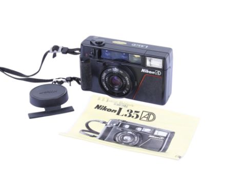 A Nikon L35 AD 35mm Compact camera. With a Nikon 35mm f2.8 lens, lens cap and instruction guide.