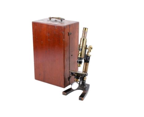 An unbranded antique brass monocular microscope. No visible makers marks. Stamped 'U.L 9'. With a Swift London 1 inch objecti