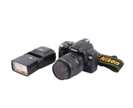 A Nikon D40X Digital SLR camera. With an AF-S Nikkor 18-55mm f3.5-5.6G II ED lens, battery, strap, and Jessops 300FDN flash. 