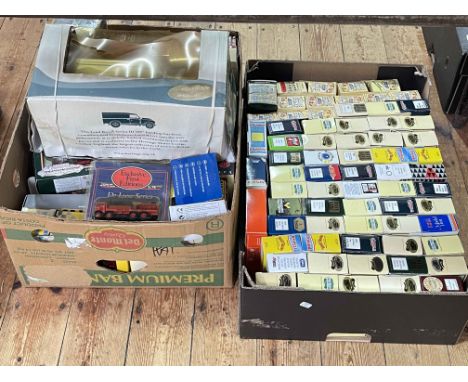 Two boxes of boxed model vehicles.