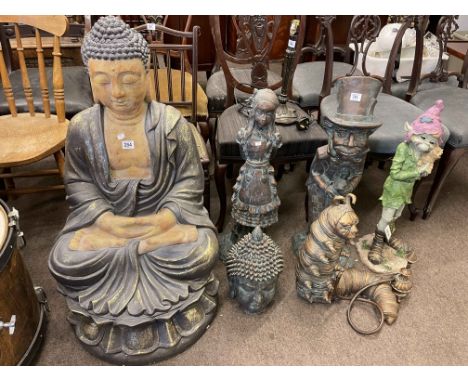 Buddha garden figure, Buddha head, three Alice in Wonderland figures, pixie and table lamp (7).